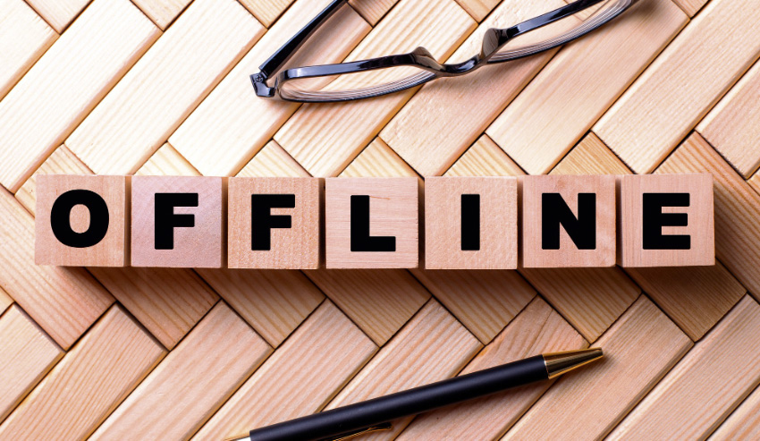Image showing OFFLINE using scrabble tiles next to a pen and glasses